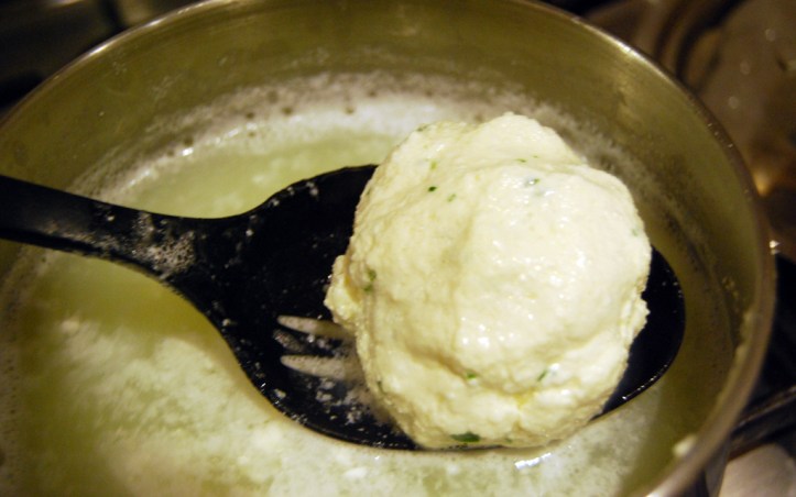 Dunking the mozzarella into whey